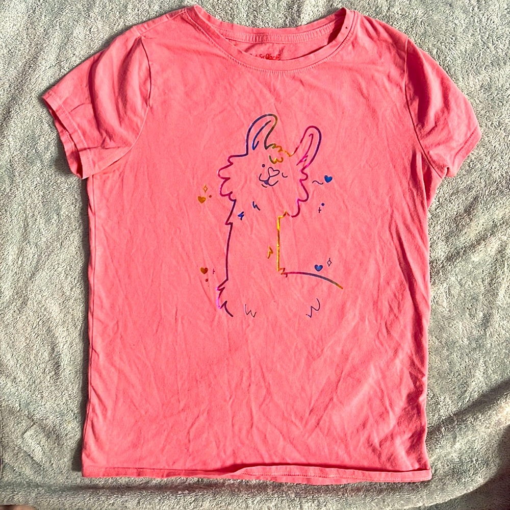 Pink/coral shirt with a colorful llama